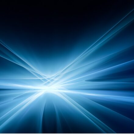 Bright white and blue light emanating rays in various directions against a dark background.