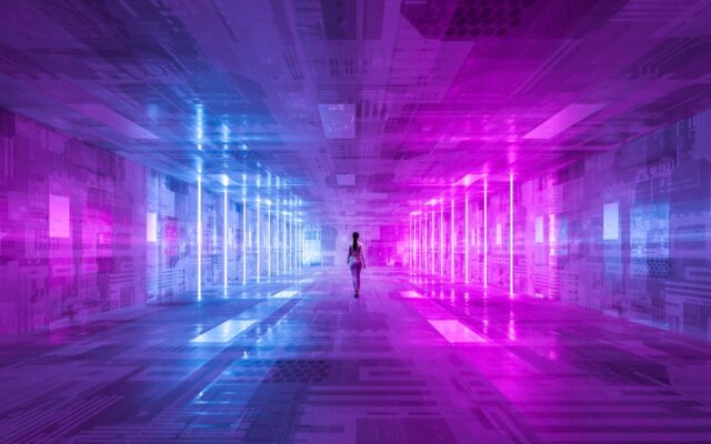 Digital image of a businesswoman walking along a futuristic corridor, lit in purple and blue.