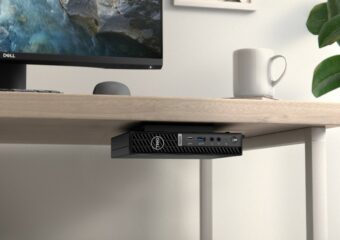 Dell OptiPlex Small Form Factor Plus 7010, secured to underside of a desk. a Dell monitor and mouse are on desk's surface with a white coffee mug nearby.