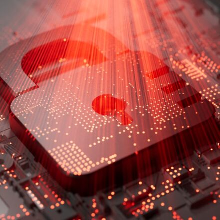 Digital image of a security lock on a motherboard with a red light glowing from above. Representative of cybersecurity and threat protection.