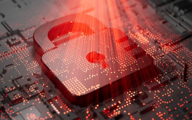 Digital image of a security lock on a motherboard with a red light glowing from above. Representative of cybersecurity and threat protection.