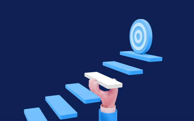 Digital graphic depicting a person's hand holding up a step on the pathway to the target.