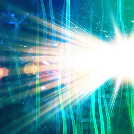 Light shining brightly from a star on the right side, extending towards the left, with green tints surrounding the rays of light.