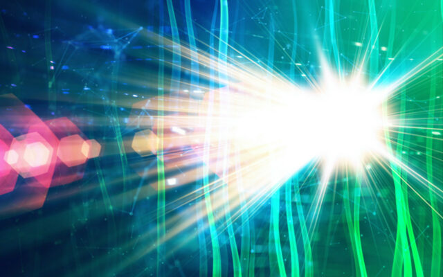 Light shining brightly from a star on the right side, extending towards the left, with green tints surrounding the rays of light.