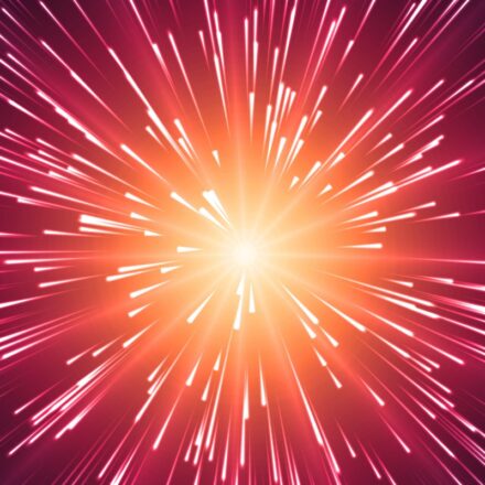 Digitally generated image of rays of light expanding from a central point, against a red and orange background, in a starburst appearance.