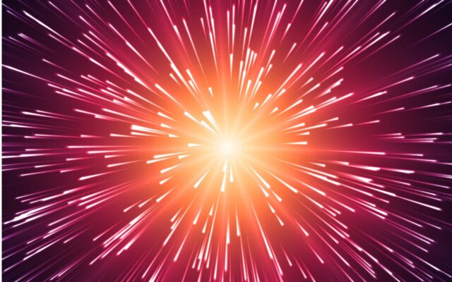 Digitally generated image of rays of light expanding from a central point, against a red and orange background, in a starburst appearance.