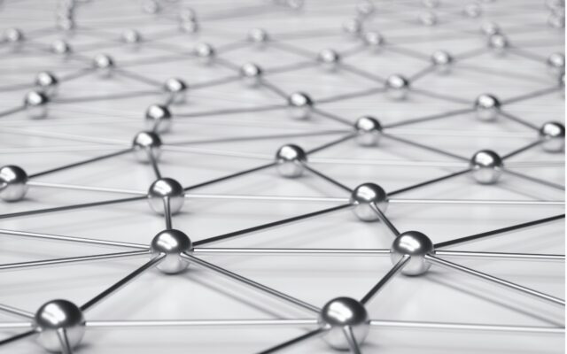 Metallic spheres connected on an off-white surface.