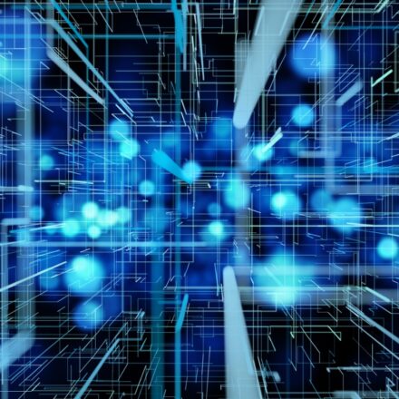 Digitally generated image of rays of light and molecules in high speed motion. They're in shades of blue and teal against a dark background.