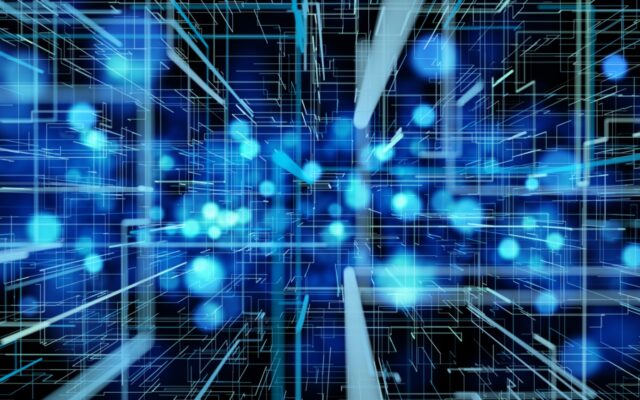 Digitally generated image of rays of light and molecules in high speed motion. They're in shades of blue and teal against a dark background.