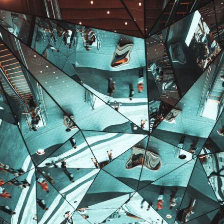 Reflections in a set of mirrors of people in motion.