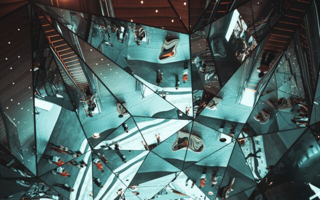 Reflections in a set of mirrors of people in motion.