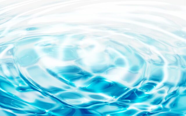 Water rippling in concentric circles against a turquoise blue background.