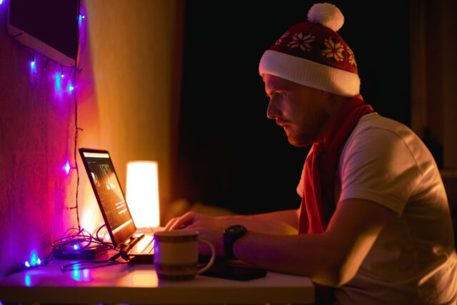 holiday freelancer working in laptop at the home. Nice color light in the room. Soon happy New year. holiday it support
