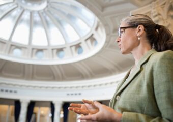 Caucasian politician talking in government building.