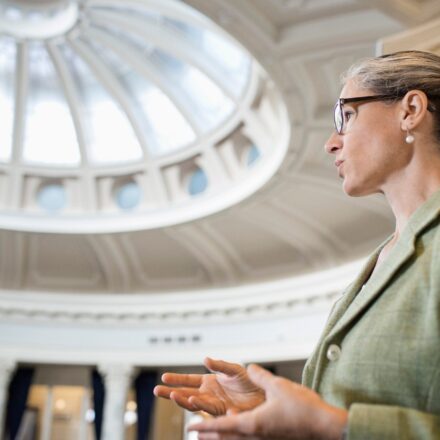 Caucasian politician talking in government building.
