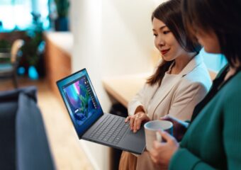 TWo women looking at a Dell Pro Max 14 premium laptop
