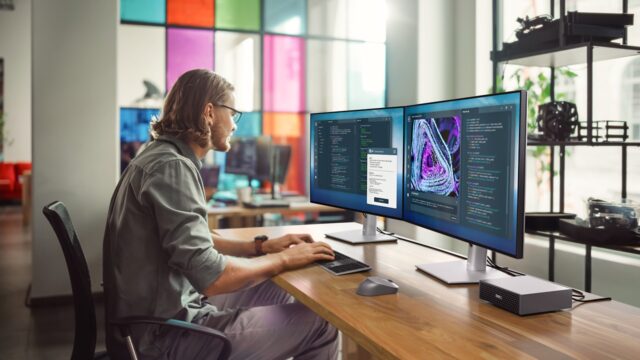 Professional working on a laptop in a modern office, representing AI powered PCs for workplace productivity with innovation and collaboration tools.